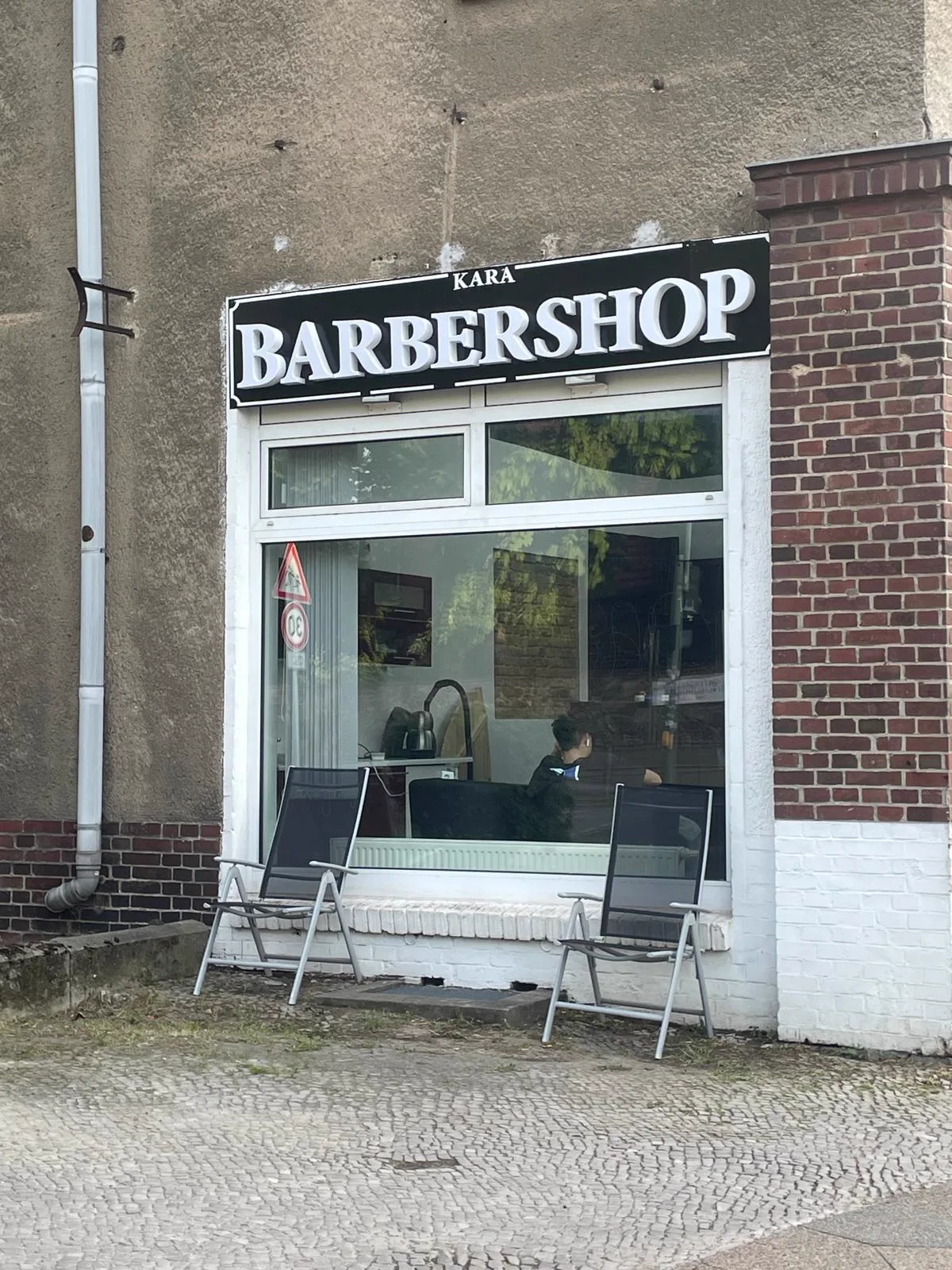 Shop window of Kara Barbershop in Berlin-Heinersdorf