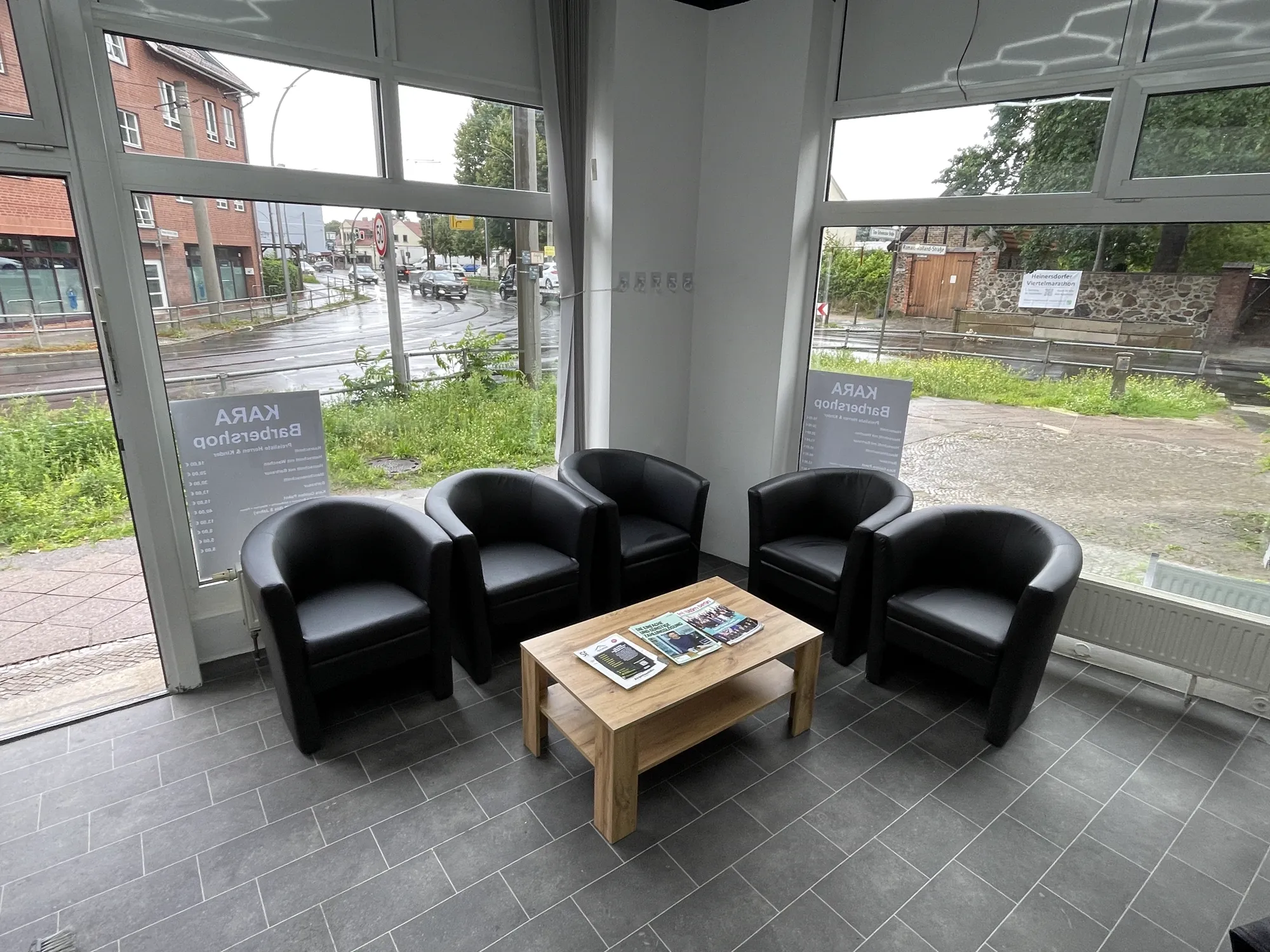 Seating corner by the window at Kara Barbershop